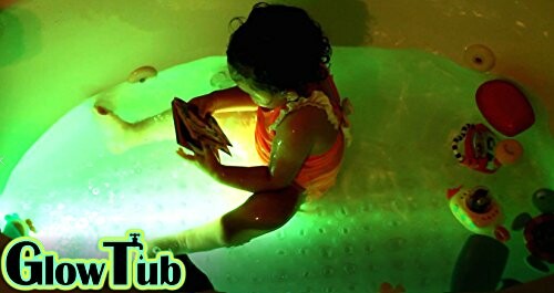 Child playing with glowing bath toys in a tub