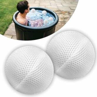 Person in a hot tub with two white insulation balls.