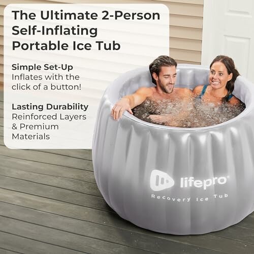 Two people in a self-inflating portable ice tub on a deck.